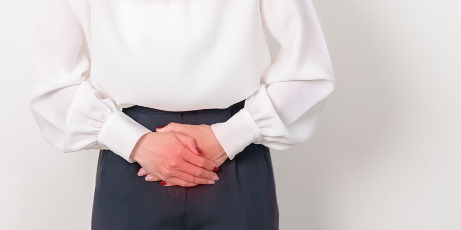 Woman with hands over her lower abdomen